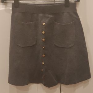 Knit skit with gold buttons and pockets